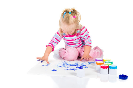 Child painting with fingers isolated on white の写真素材