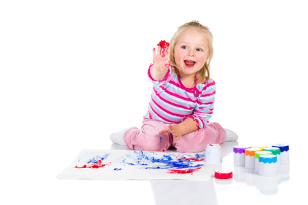 Child painting with fingers isolated on white の写真素材