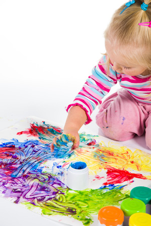 Child painting with fingers isolated on white の写真素材