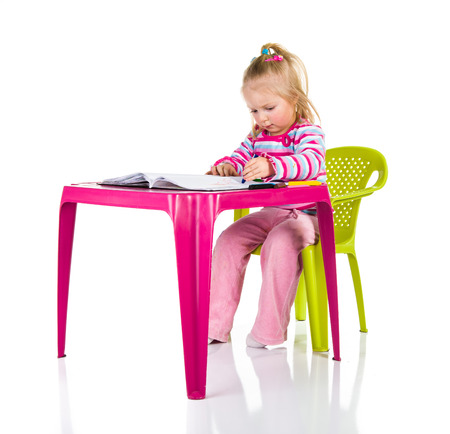 Child drawing with crayons isolated on whiteの写真素材