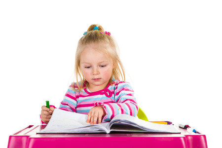 Child drawing with crayons isolated on whiteの写真素材