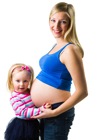 Pregnant woman with 2 zo daughter on whiteの写真素材