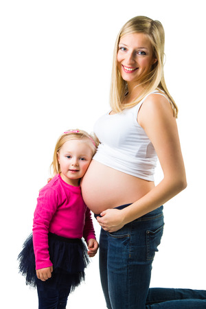 Pregnant woman with 2 zo daughter on whiteの写真素材