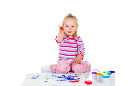 Child painting with fingers isolated on white の写真素材