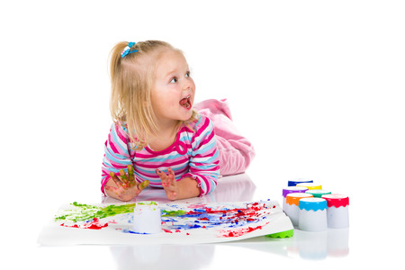 Child painting with fingers isolated on white の写真素材