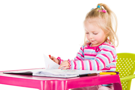 Child drawing with crayons isolated on whiteの写真素材