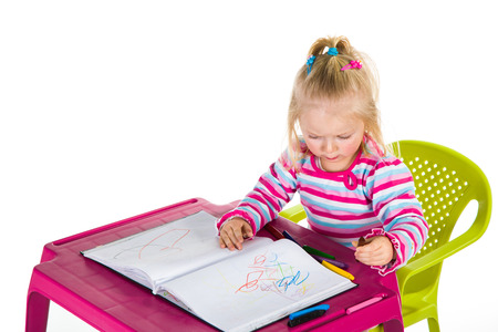 Child drawing with crayons isolated on whiteの写真素材