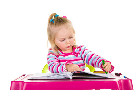 Child drawing with crayons isolated on whiteの写真素材