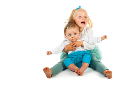 Preschool girl holding newbornの写真素材