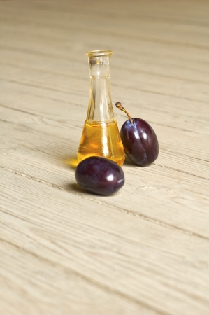 Plum brandy over a wooden backgroundの写真素材