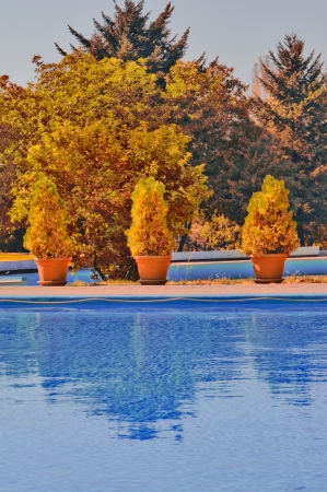 Outdoor swimming pool in sunsetの写真素材