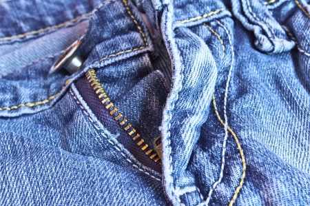 Closeup picture of blue jeans trousers with an open zipper の写真素材