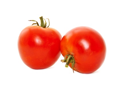 Two fresh tomatoes with green leavesの写真素材