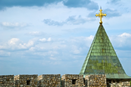 Cross on church roof top with a blue and white sky in backgroundの写真素材