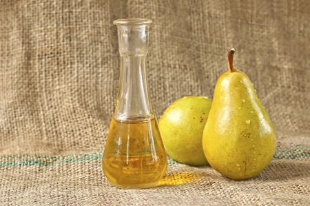 Pears brandy or schnapps with fresh and tasty pears fruit on a table cloth の写真素材