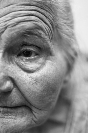 Old woman wrinkled face close up  Selective focus on eye の写真素材