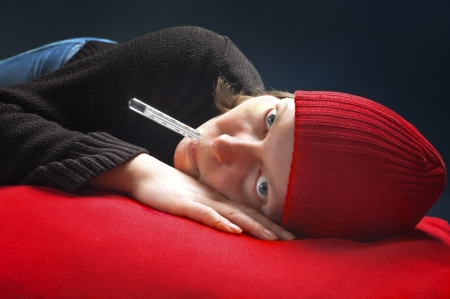 A young girl holding thermometer with lips  Healthcare and medicine concept の写真素材