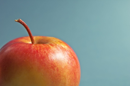 Tasty red apple over a blue background  Macro の写真素材