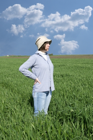 Female farmer in a weath field against blue sky の写真素材