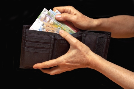 Black wallet with money in hands  Swiss francs banknotes の写真素材