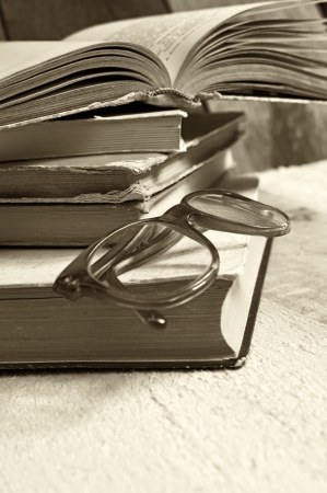 Old books with reading glasses  Selective focus on glasses の写真素材