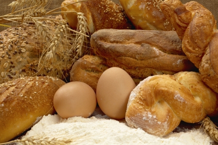 Still life with tasty fresh crunchy bread and raw eggs の写真素材