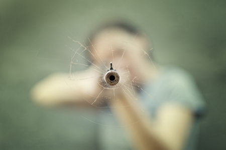 Woman with a rifle  Selective focus on the barrel の写真素材