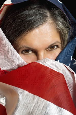 Adult woman wrapped in a United States flag の写真素材