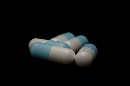 Capsule pills isolated on black background