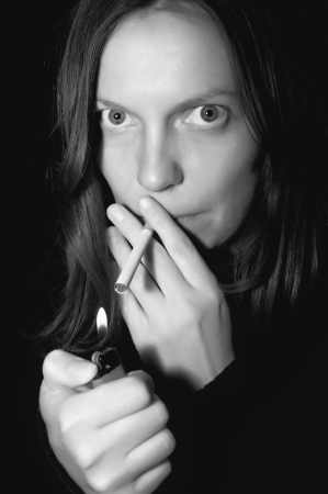 Black and white photo girl with cigarette の写真素材