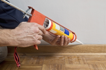 Caulking silicone from cartridge on wooden batten の写真素材