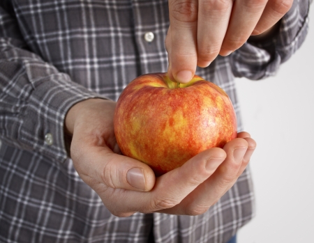 Hands holding tasty red apple の写真素材