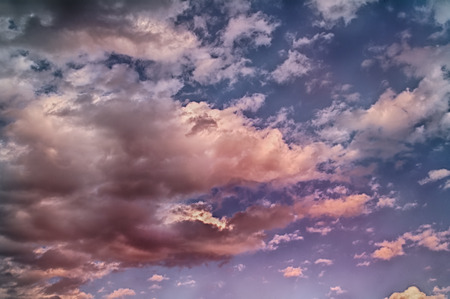 Pink clouds in the evening sky. Fluffy clouds in winter day.の写真素材