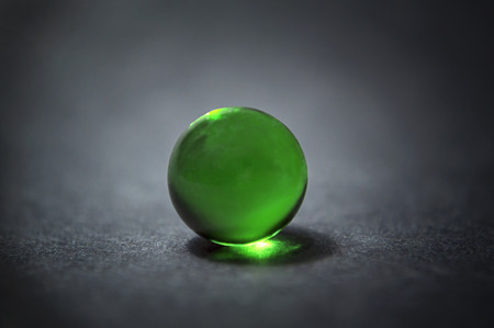 Closeup of a green marble ball with reflection.の写真素材