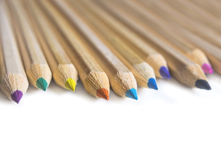 Color crayon pencils isolated on white background. Shallow depth of field.
