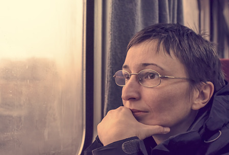 Portrait of worried woman in train. Thinking and wondering concepts.
