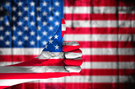 Hand with thumbs up covered in American flag.の写真素材