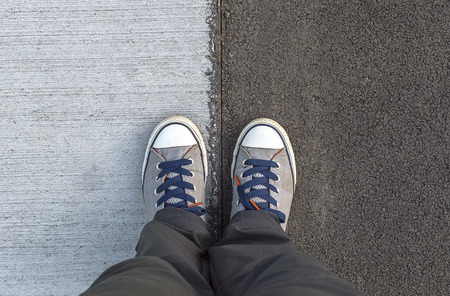 Top of view sneakers on a road. Selective focus.