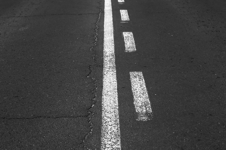 Double white grunge line on asphalt road.の写真素材