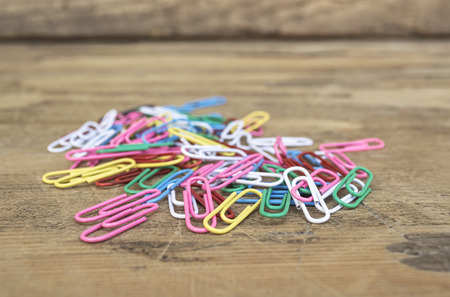 Colorful paper clips on wooden table. Selective focus.の写真素材