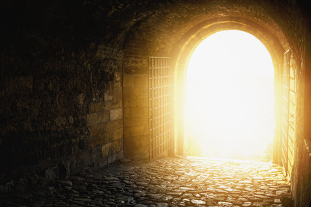 Door to Heaven. Arched passage open to heaven`s sky. Light at end of the tunnel. Hope metaphor.の写真素材