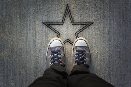 Sneakers on asphalt road with star shapeの写真素材