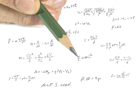 Close up of hand showing physics formula on paper