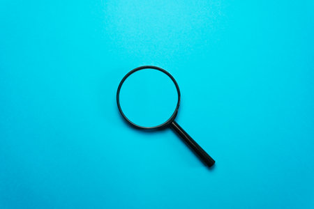 Magnifying glass isolated on blue backgroundの写真素材
