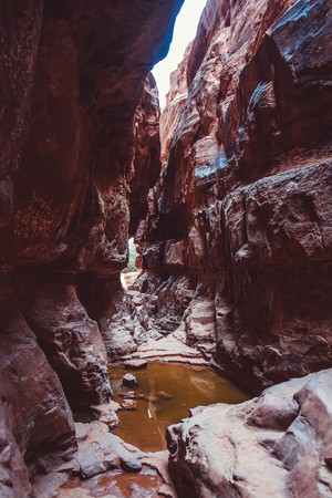 Tourist climbs on the rocks in the canyon of Khazali. Wadi Rum Desert, Jordanの写真素材