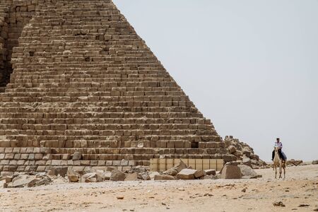 Giza, Egypt - 2018: Front view of tourists in a horse-drawn carriage with the ancient pyramids of Giza on backgroundのeditorial素材