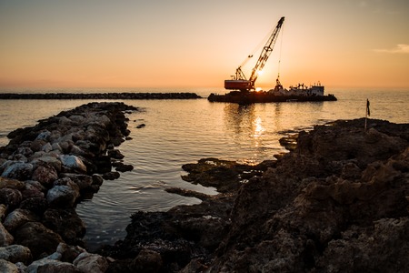 sailing boat sunset at beach in Cyprusの写真素材