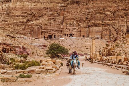 PETRA, JORDAN - May 2018:Jordanian Bedouin man rides a donkey in Petra on November 09 2007.Petra was originally the capital city of the Nabataeans, an ancient Arab civilization.のeditorial素材
