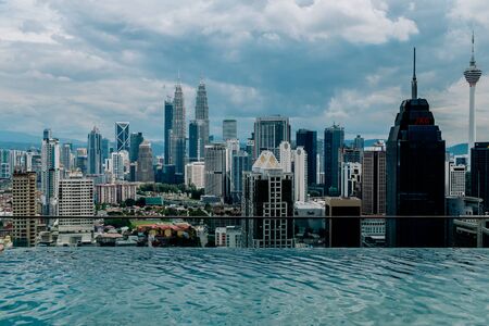 Nov 2018. Petronas Twin towers seen from skyscrapper's roof with pool, Kuala Lumpur central park, KLCCのeditorial素材