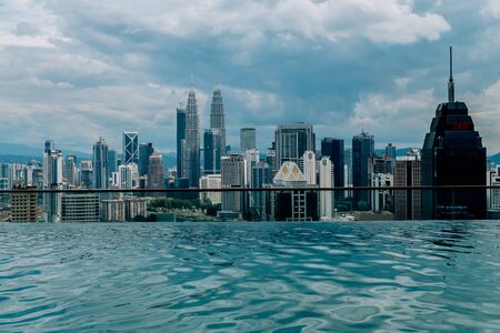 Nov 2018. Petronas Twin towers seen from skyscrapper's roof with pool, Kuala Lumpur central park, KLCCのeditorial素材